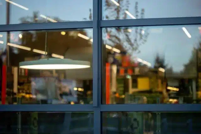 Reflection of the store visible in the glass showcasing the building exterior and surrounding environment