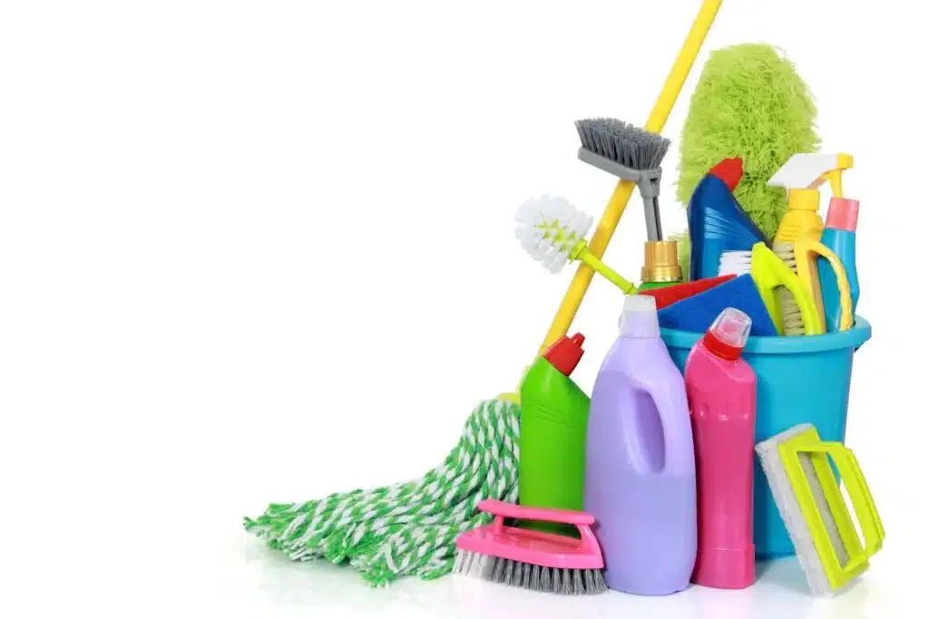 A bucket filled with cleaning supplies, including a brush and sponge ready for use in cleaning tasks
