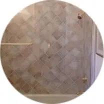 See-through shower door with contemporary metallic knob.