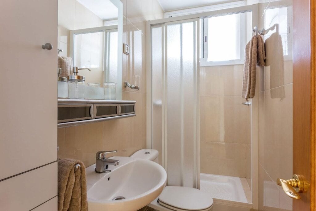 A clean bathroom featuring a sink, toilet, and shower, designed for functionality and comfort