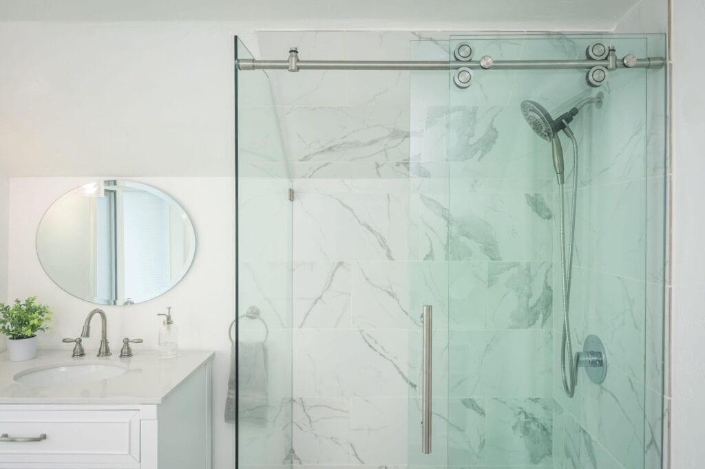 A modern bathroom with a glass shower door and a sleek sink.