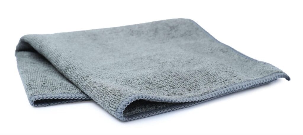 Gray towels laid out on white table