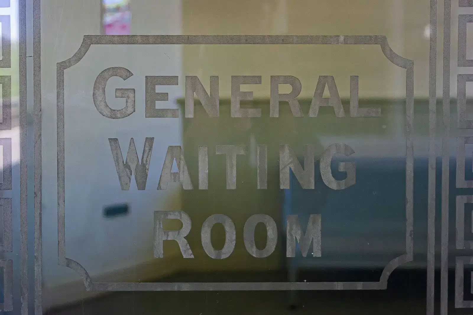 A glass door featuring an etched sign indicating the general waiting room, enhancing the entrance's professional appearance