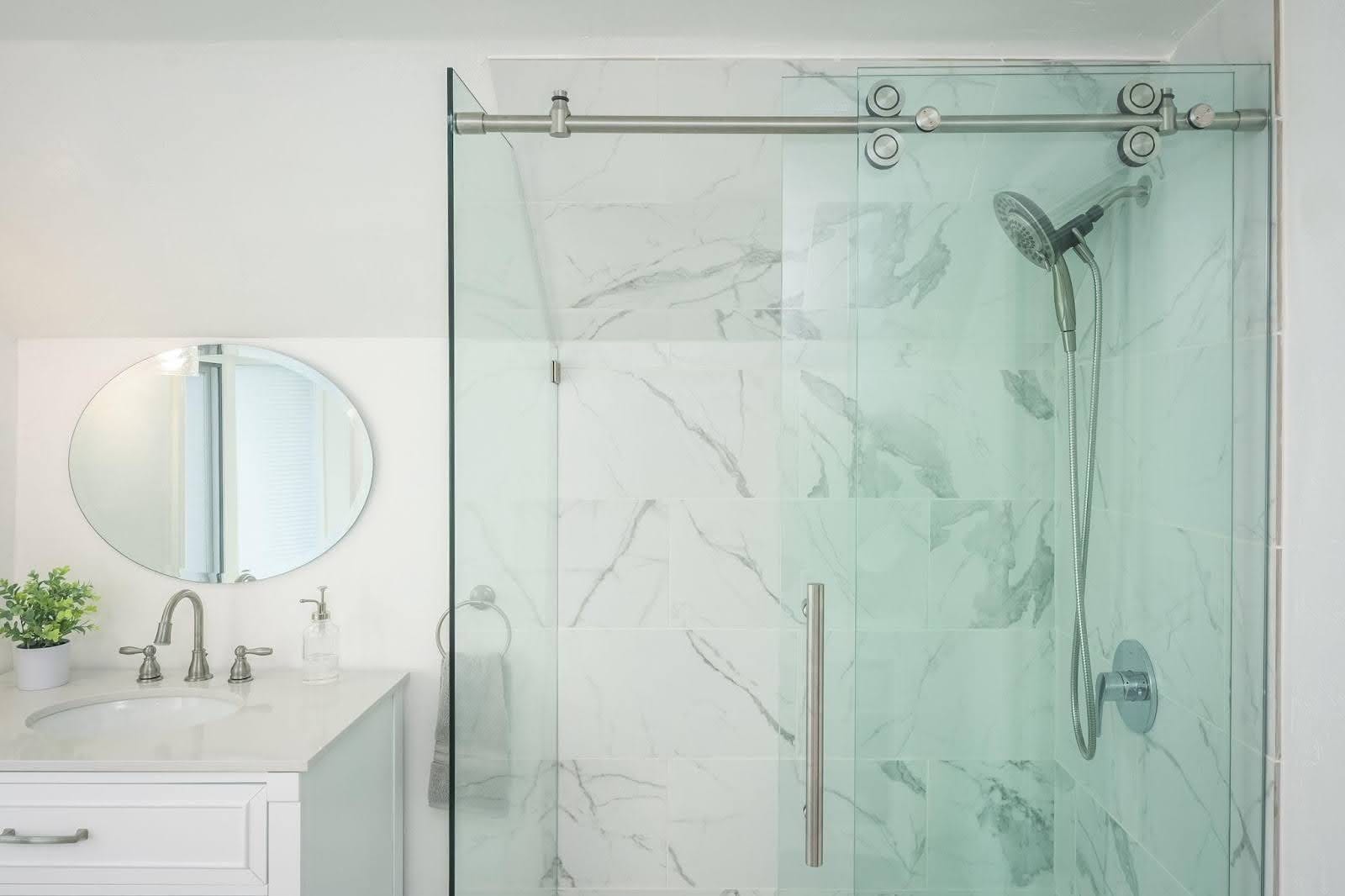 A modern bathroom with a glass shower door and sleek sink, showcasing a stylish design