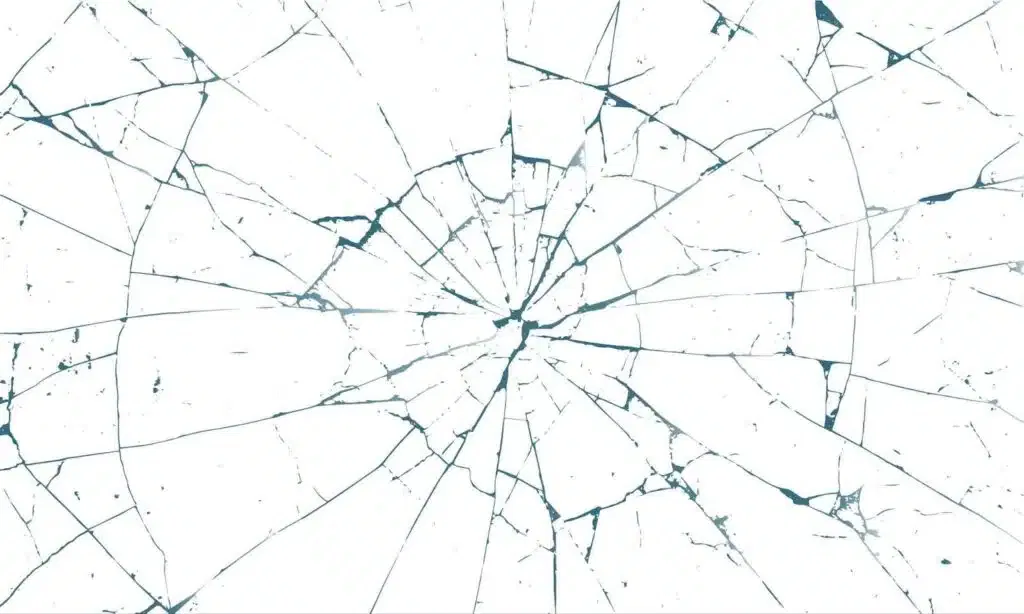 A cracked glass on a blue backdrop, showcasing delicate patterns from its imperfections
