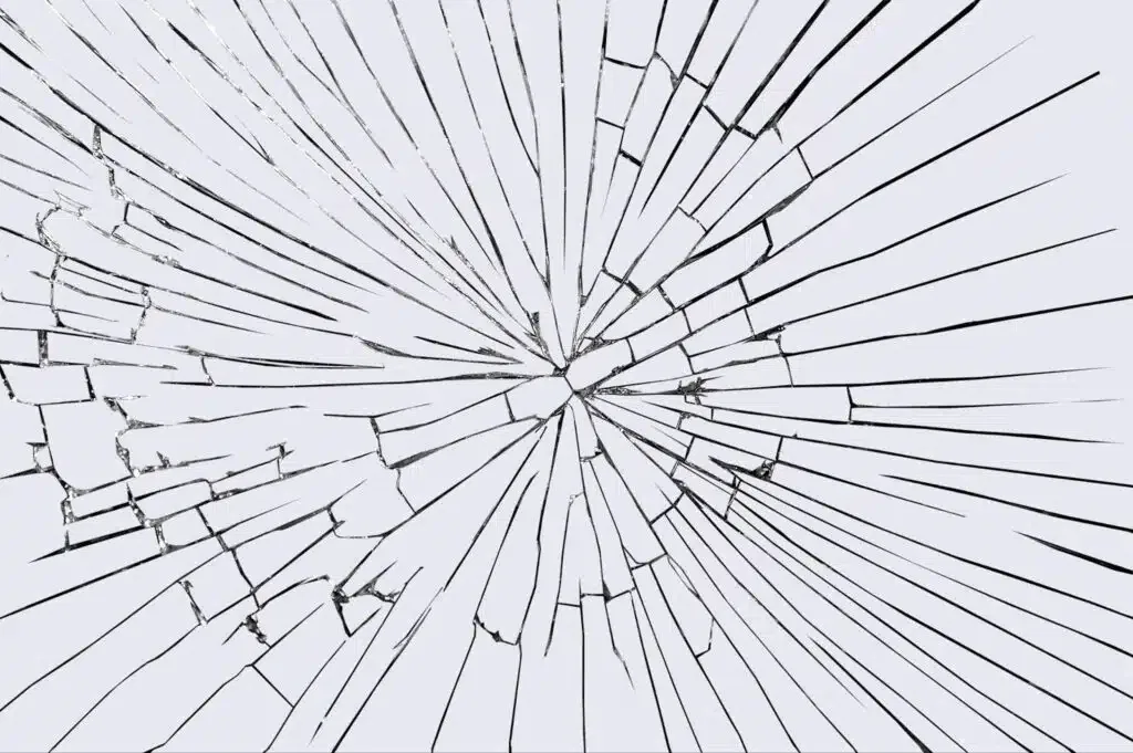 An image depicting a shattered glass with a visible crack, highlighting its damaged state