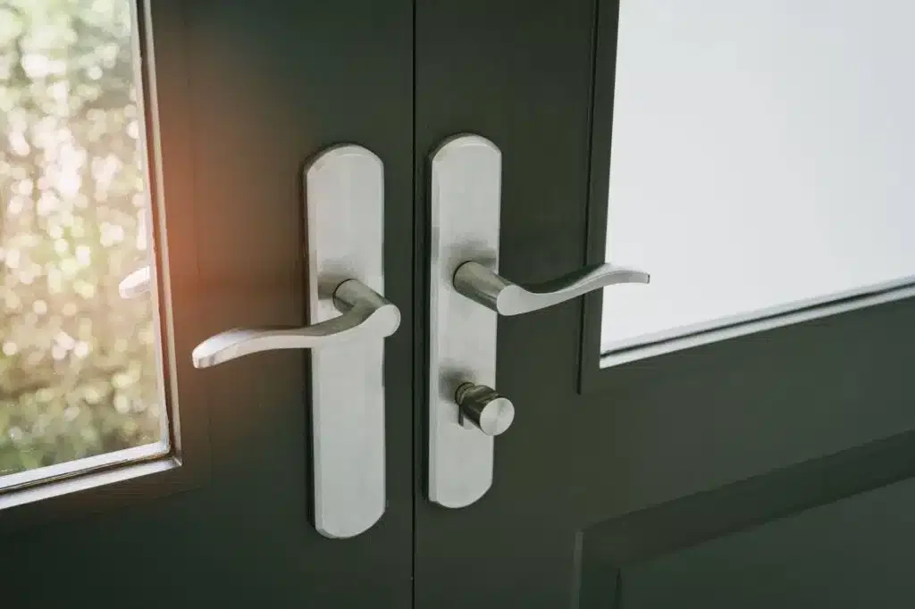 Close-up of a modern door handle on a sleek black door