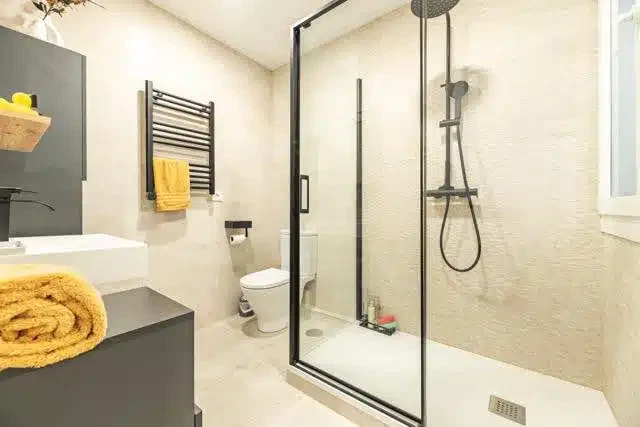 An elegant bathroom space with polished tiles a stylish sink, and a bathtub designed for comfort and relaxation