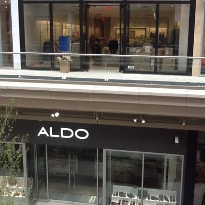 Exterior of Aldo store in a bustling mall, showcasing trendy shoes and accessories.
