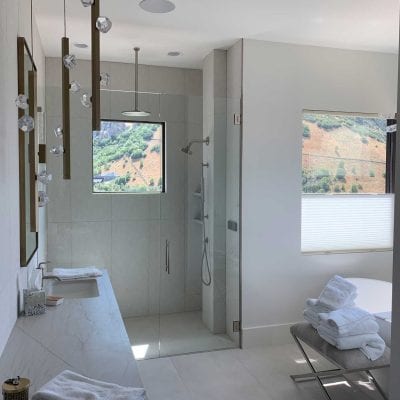 A bathroom with a shower, sink, and tub.
