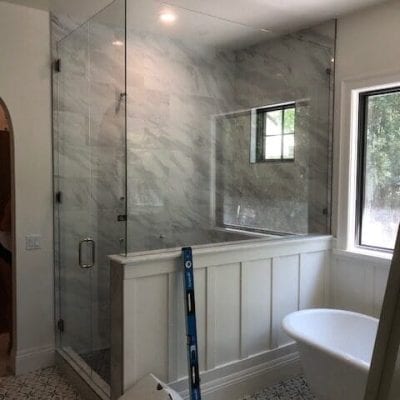 A bathroom with a tub and shower, featuring modern fixtures and a sleek design.