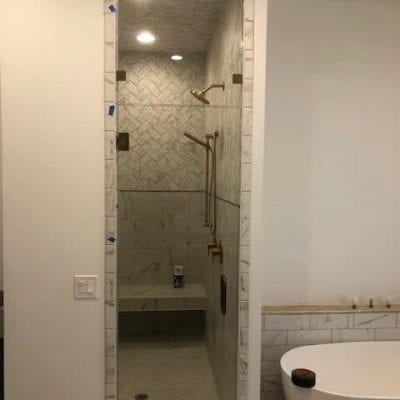 A bathroom with a tub and shower, providing a relaxing and refreshing space for personal hygiene.