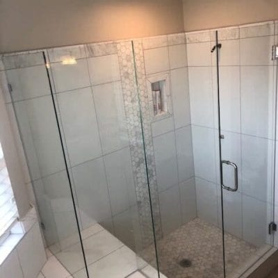 Bathroom with glass shower door and sink.