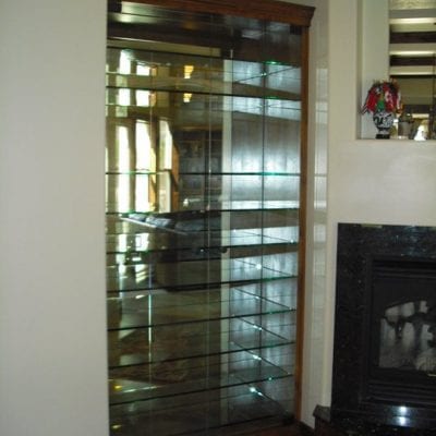 Glass door reflecting mirror inside, creating illusion of endless reflections.