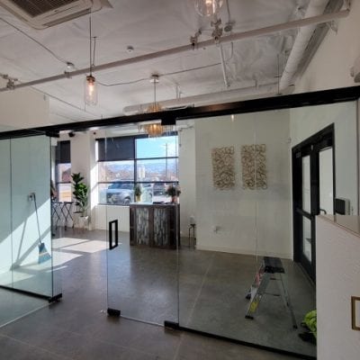 Spacious room with white walls and a large glass door.