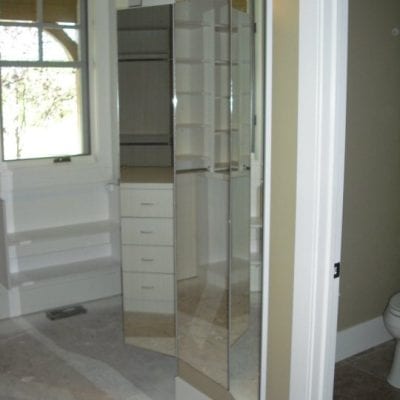 A bathroom with a mirror and a toilet.