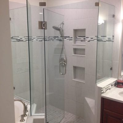 A modern bathroom with a glass shower door and a sleek sink.