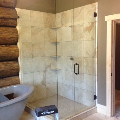 A bathroom showcasing a glass shower door and a contemporary sink design.