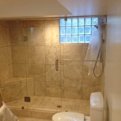 Contemporary bathroom with transparent shower enclosure.