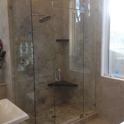 Spacious bathroom with glass shower door.
