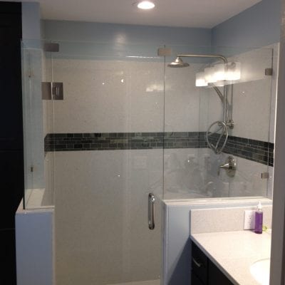 A modern bathroom with a transparent shower door and a sleek sink.