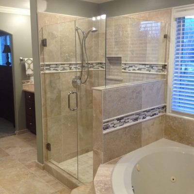 A spacious bathroom featuring a walk-in shower and bathtub.