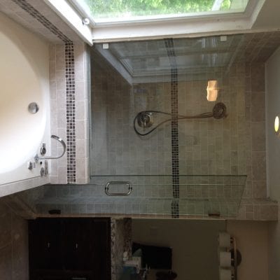 A spacious bathroom featuring a large tub and shower, perfect for relaxation and rejuvenation.