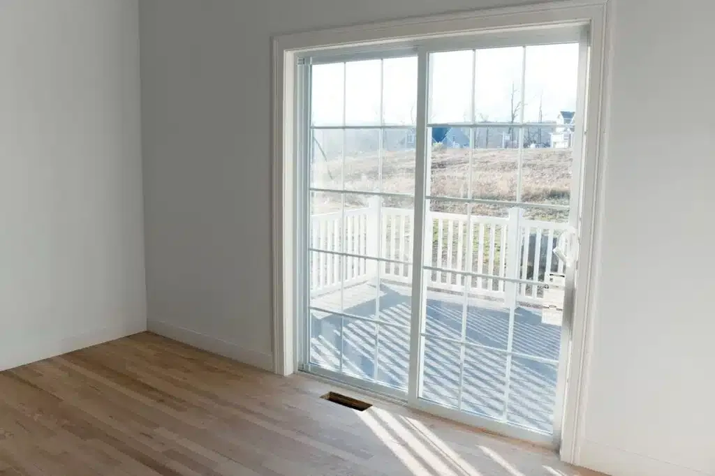 Empty room with wooden floor and glass sliding doors